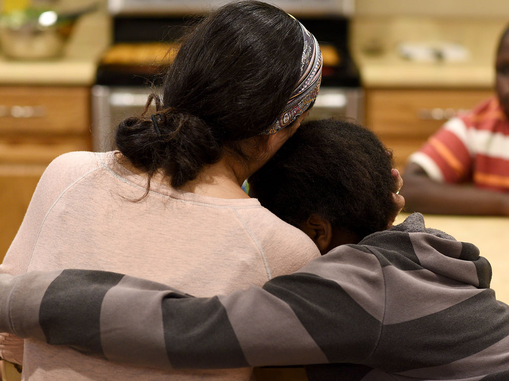 Violeta Douce hugs a 13-year-old resident